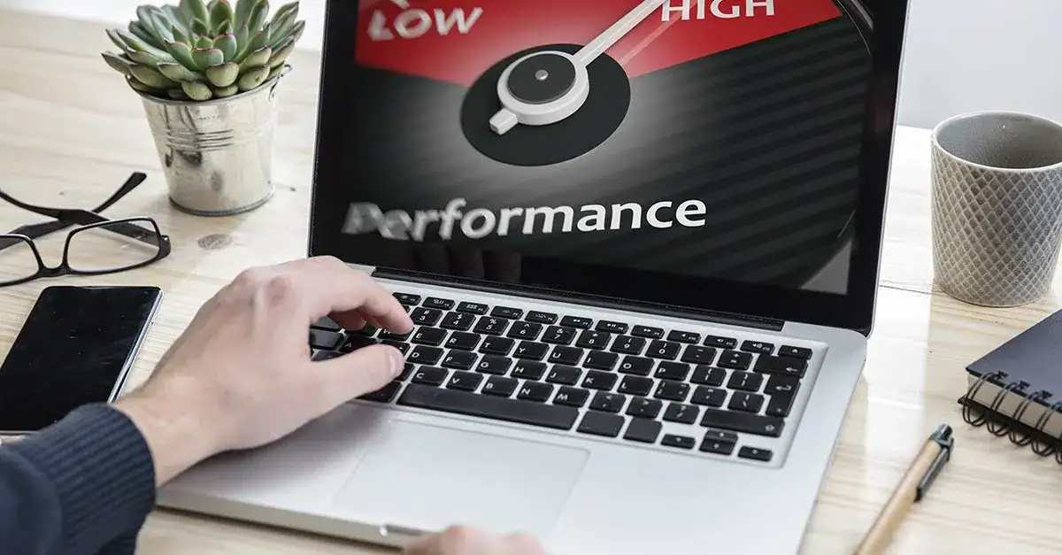 Laptop screen showing performance gauge from low to high, related to PC optimization.