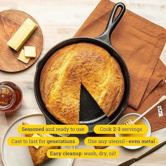 Golden baked cornbread in cast iron skillet with butter and honey, ready to serve.