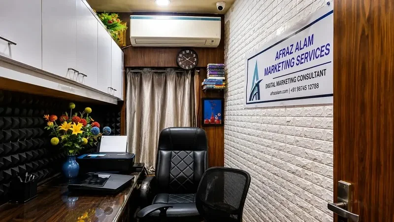 Afraz Alam's home office in Kolkata with a desk, ergonomic chairs and the Afraz Alam Marketing Services sign