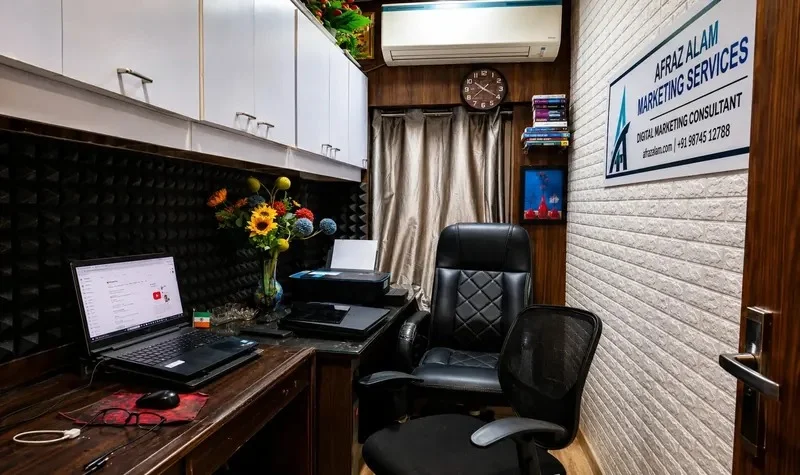 Laptop workstation in Afraz Alam's home office with acoustic panels and an ergonomic chair